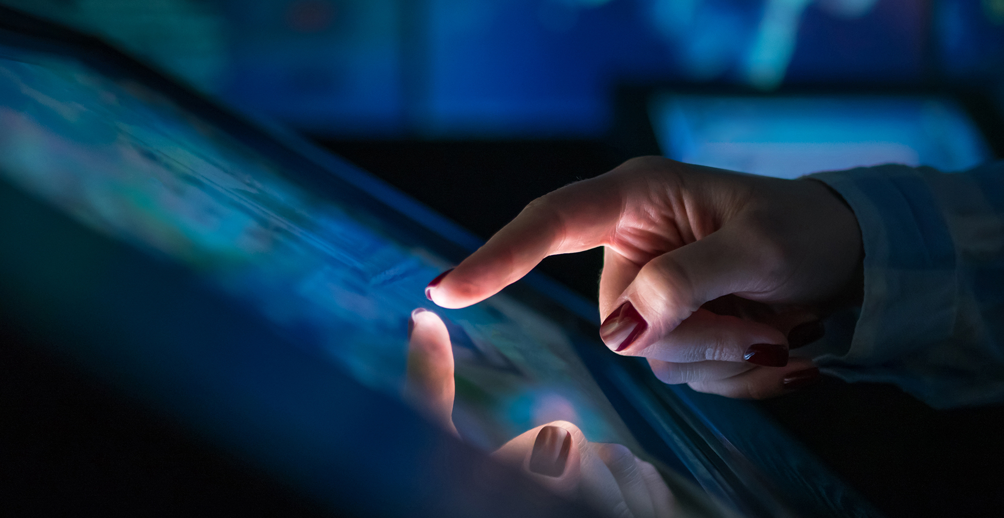 Woman's hand interacting with touch screen