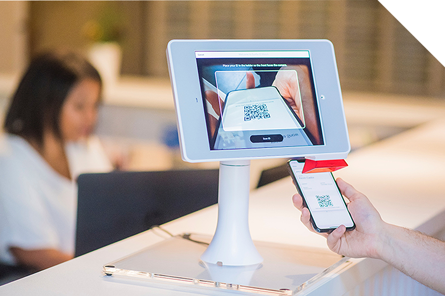 Person scanning QR code through check-in kiosk scanner