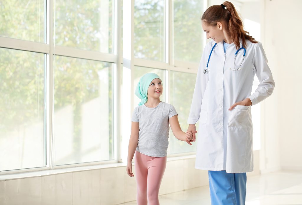 Doctor and little girl in clinic. Childhood cancer awareness concept