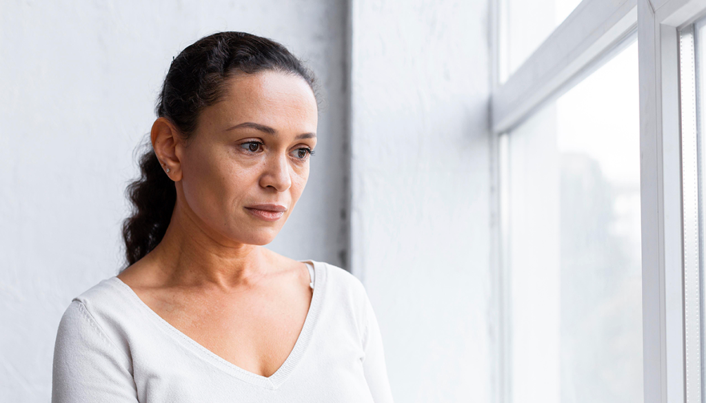 sad-woman-looking-through-window-group-therapy-session