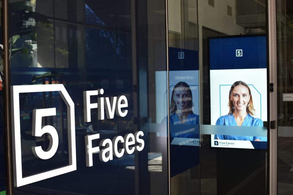 Five Faces front office neon sign and digital signage screen displaying nurses face